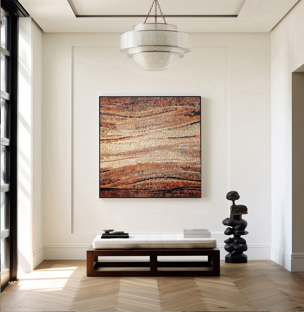 Mosaic wall art featuring a wave pattern in amber, brick, and brown tones with a creamy sand-colored center