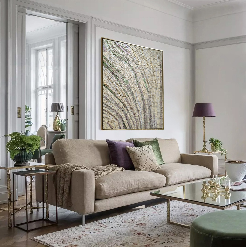 Mosaic wall art with pastel green, lavender, and gold tones forming an abstract plant-like bud on a cream background