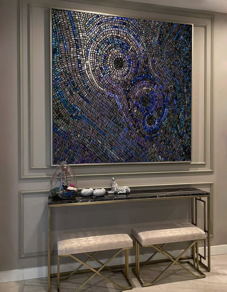 Large mosaic wall art with concentric circles in iridescent indigo, peacock blue, and sapphire shades, creating a dramatic and textured modern design